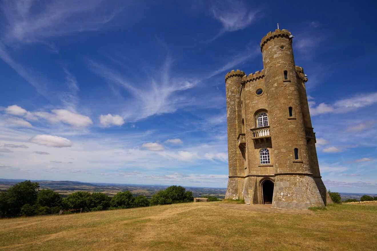 A stone tower sits on top of a grassy hill.