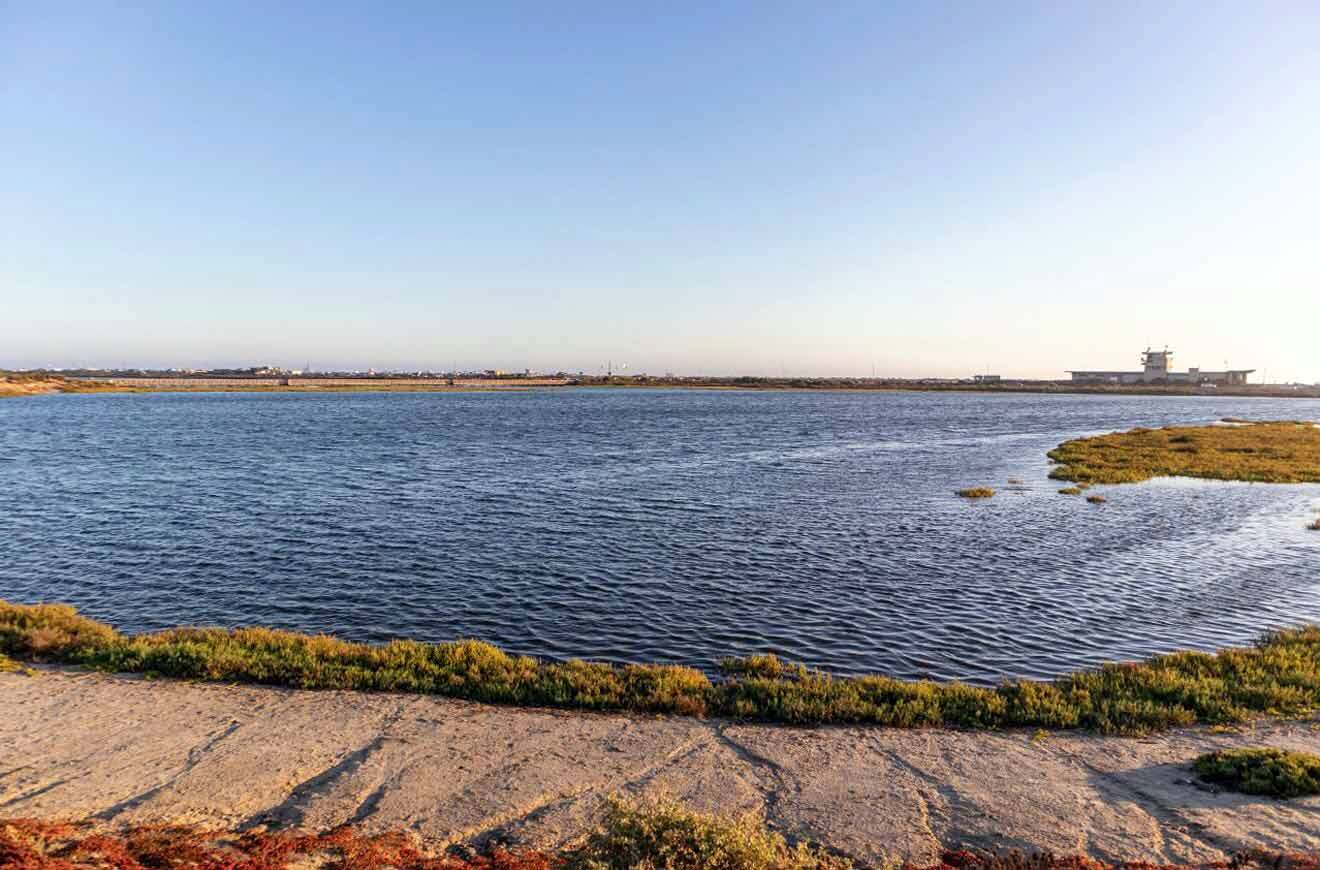 A large body of water with a building in the background.