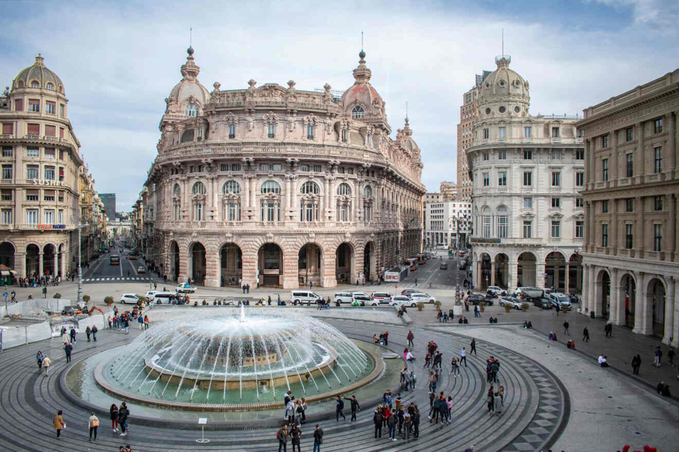 A fountain in the middle of a square with people walking around.