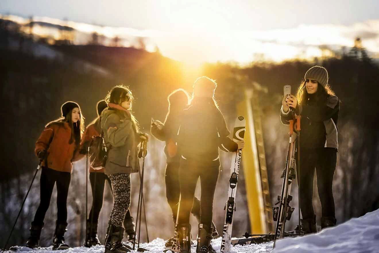 A group of people standing on skis in the snow.