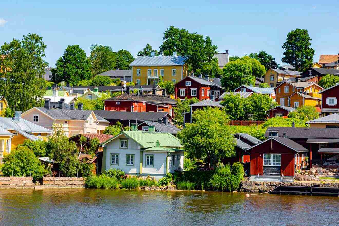 Colorful houses on a hillside near a body of water.