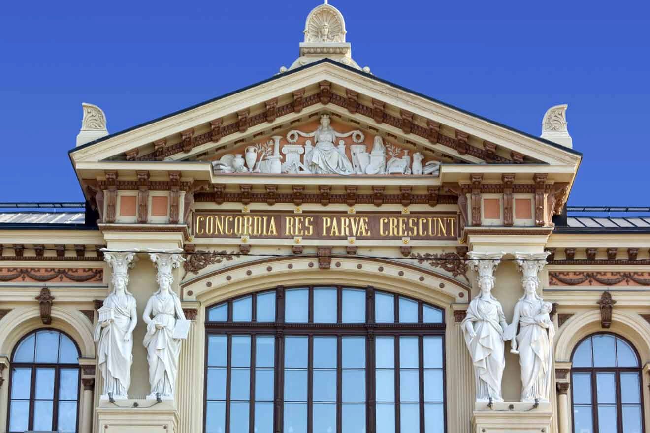 An ornate building with statues and a blue sky.