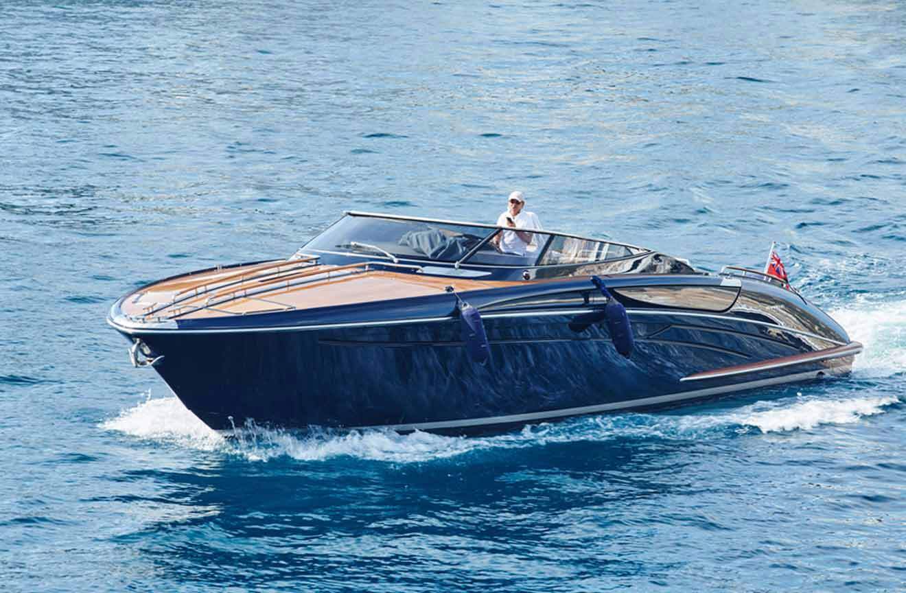 A man is riding a speed boat in the ocean.