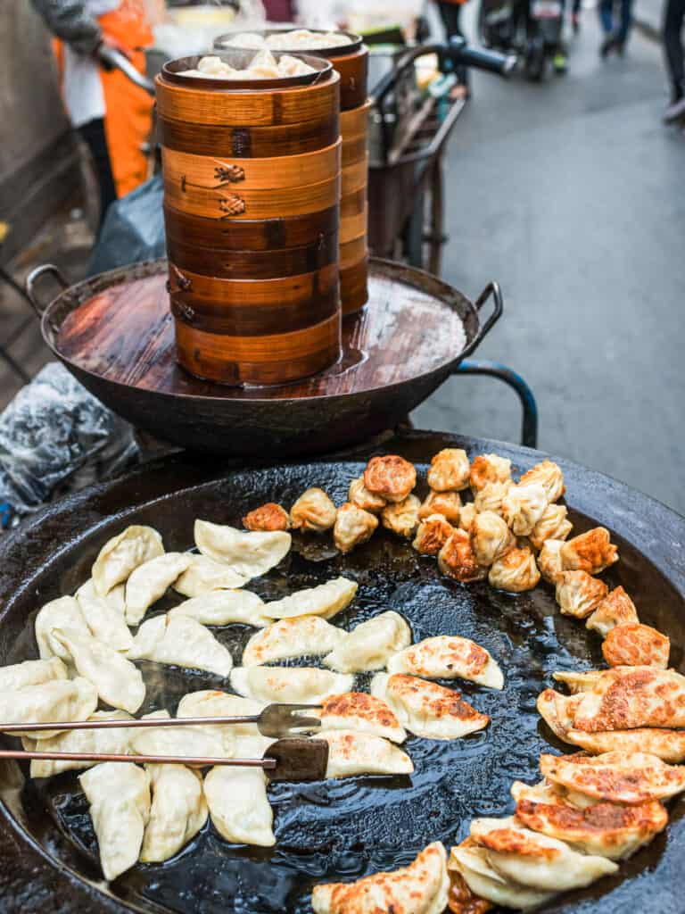 table filled with dumplings and steamer