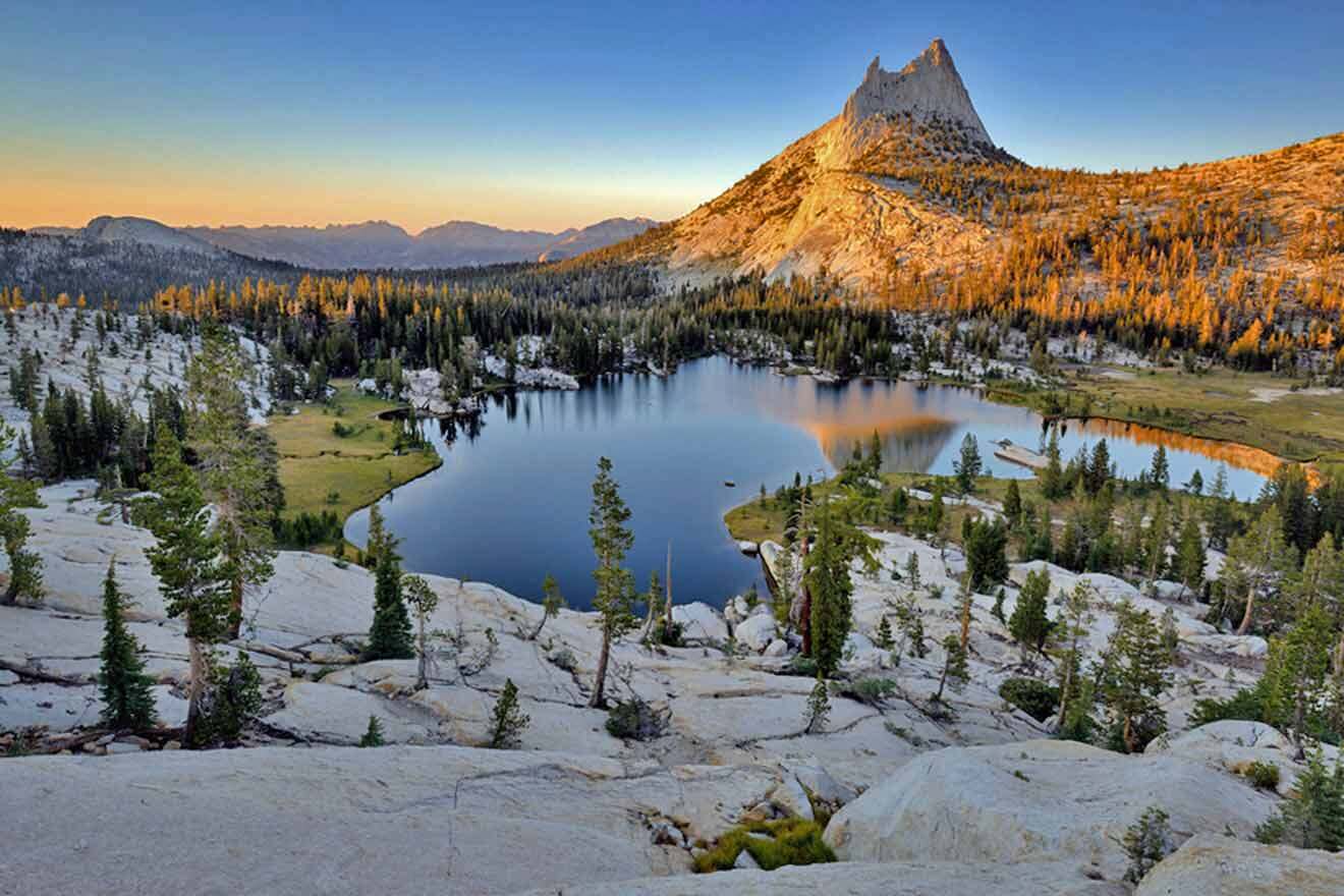 lake with rocks and trees at sunset