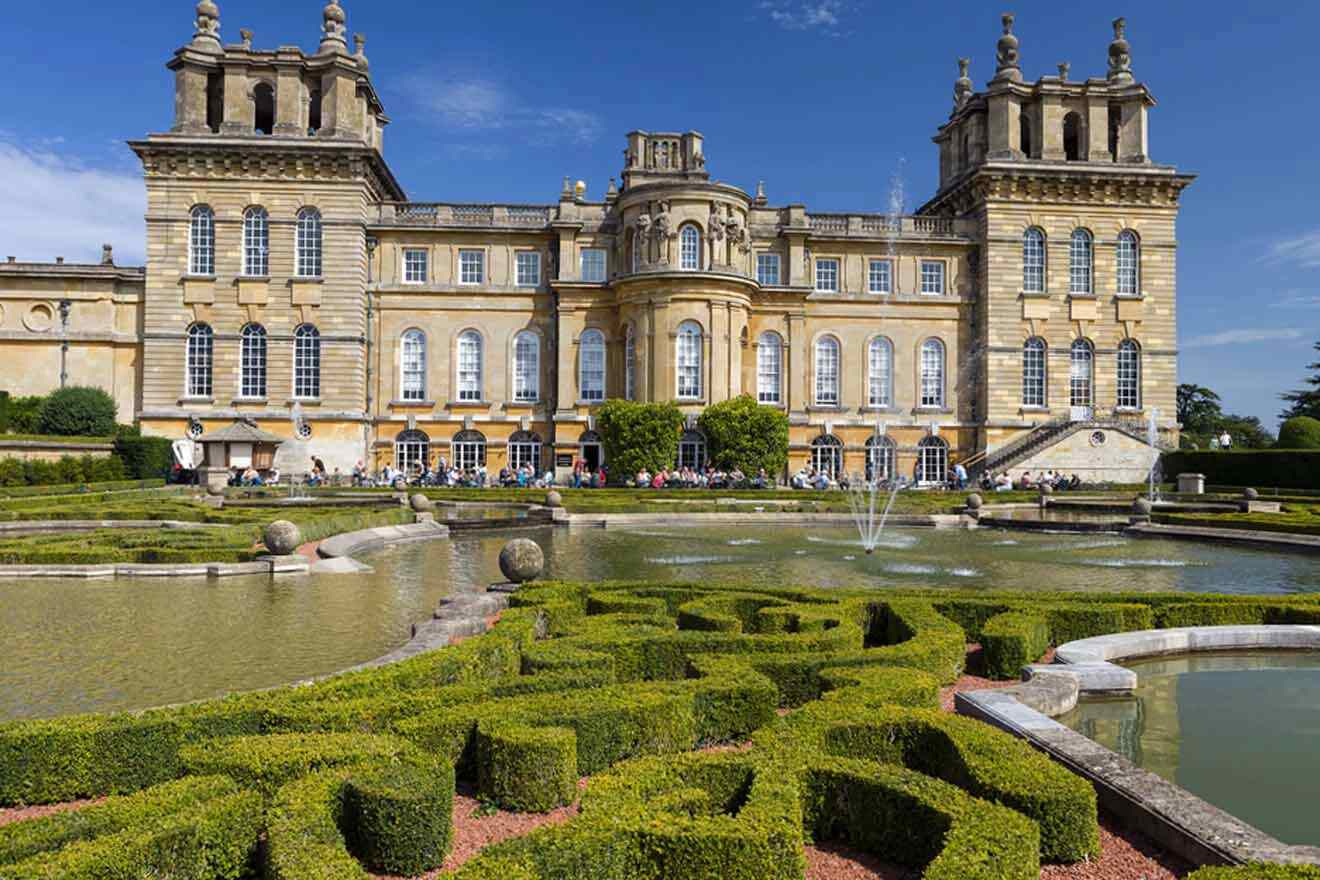 A large mansion with a fountain in front of it.