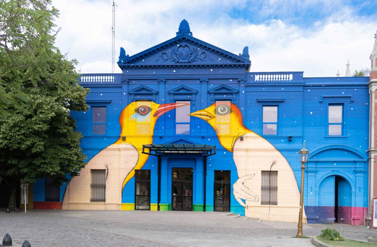 museum exterior with a mural of two birds