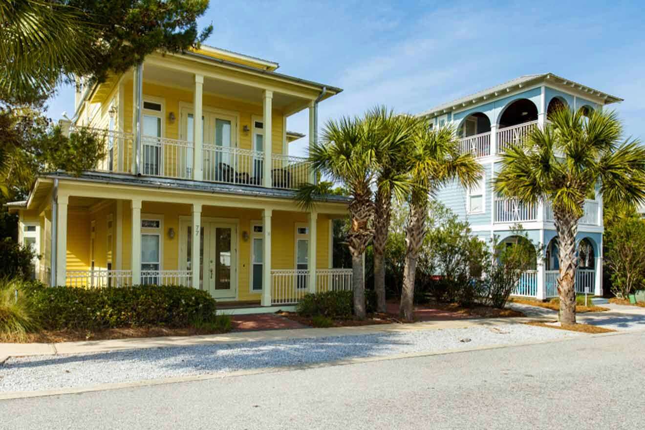 A yellow house with palm trees in front of it.