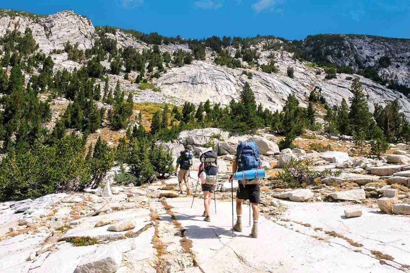 A group of hikers hiking up a rocky trail.