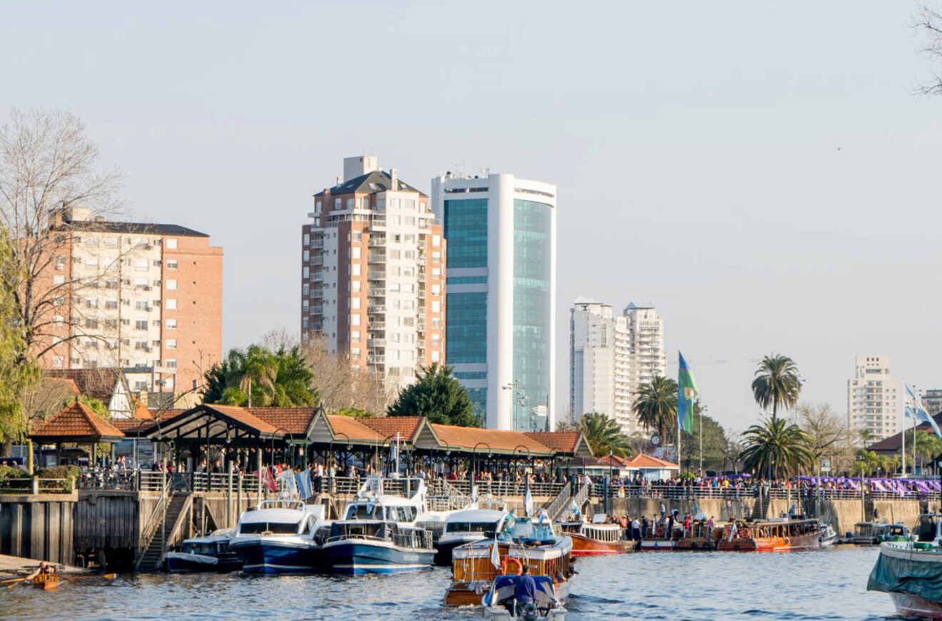 A river with boats on it and city buildings in the background