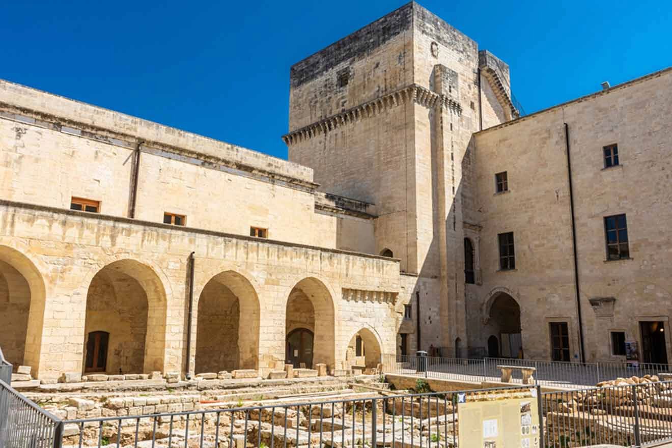 A courtyard with arches and pillars in a stone building.