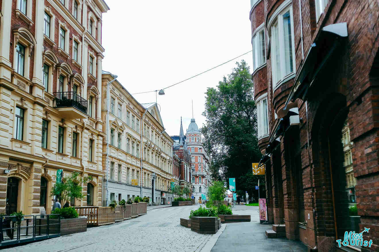 A cobblestone street lined with brick buildings.