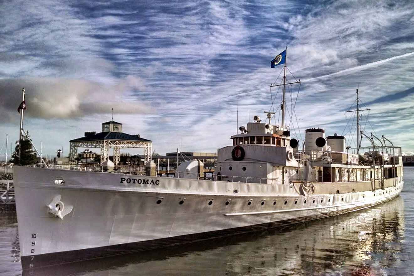 A large white boat docked in a body of water.