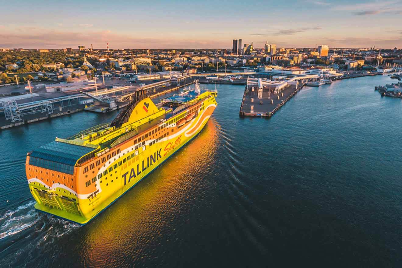 A yellow and orange cruise ship in a harbor.