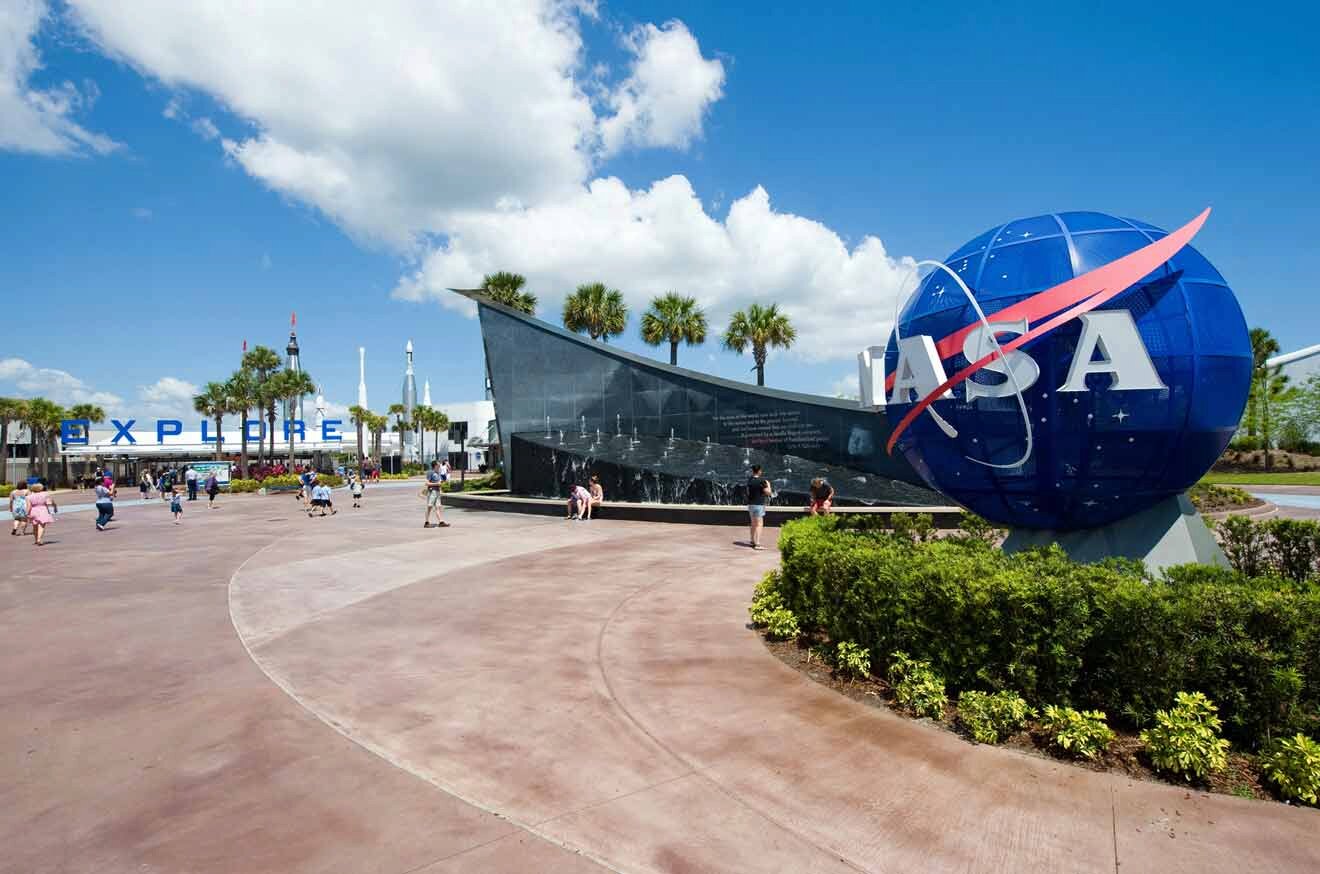 The nasa sign is in front of the entrance to kennedy space center