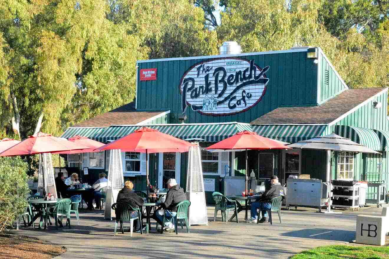 A restaurant with tables and chairs outside.