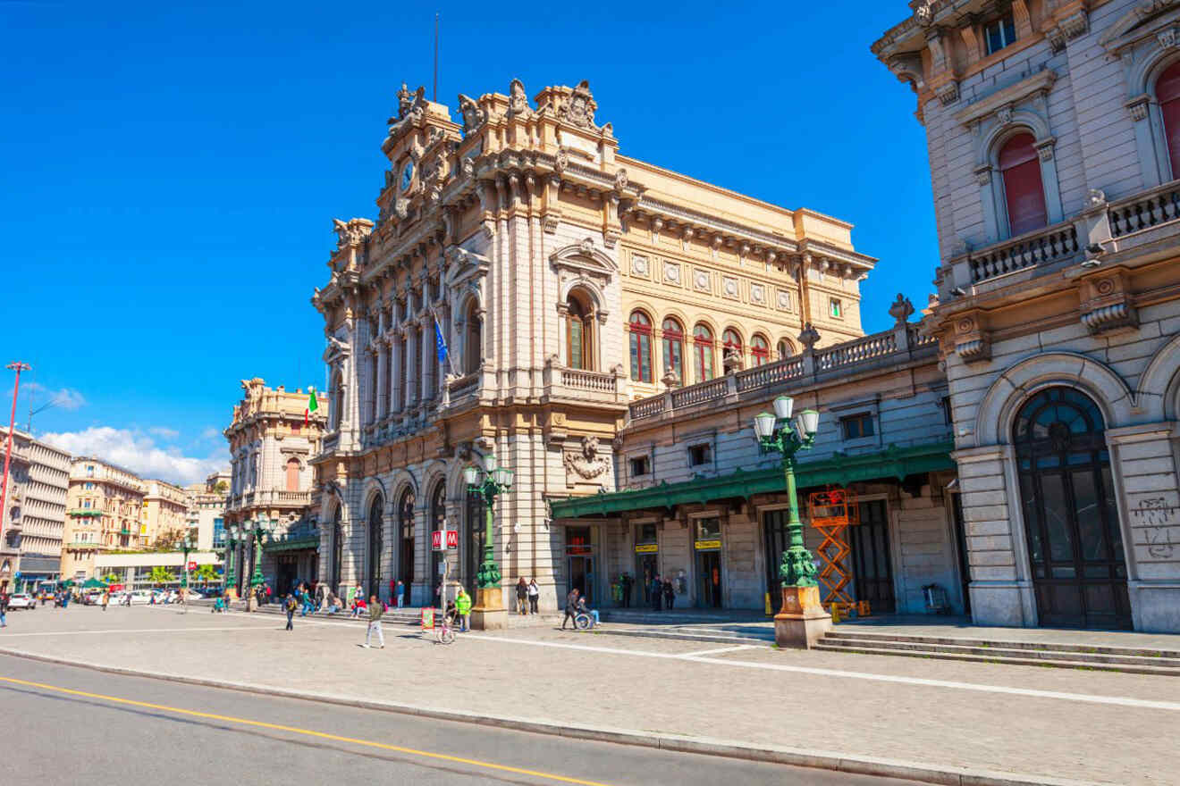 An ornate building with people walking in front of it.