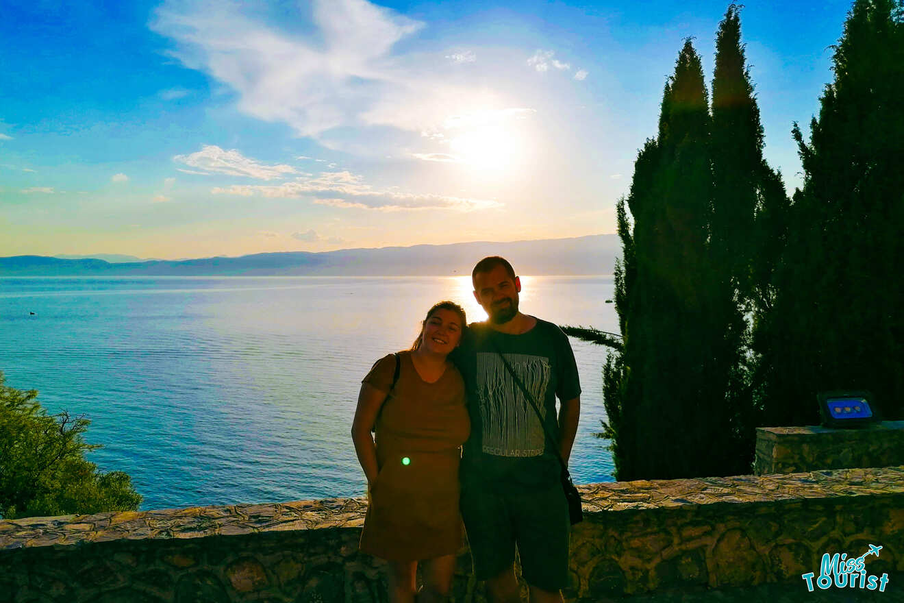 a couple posing at sunset on a lake