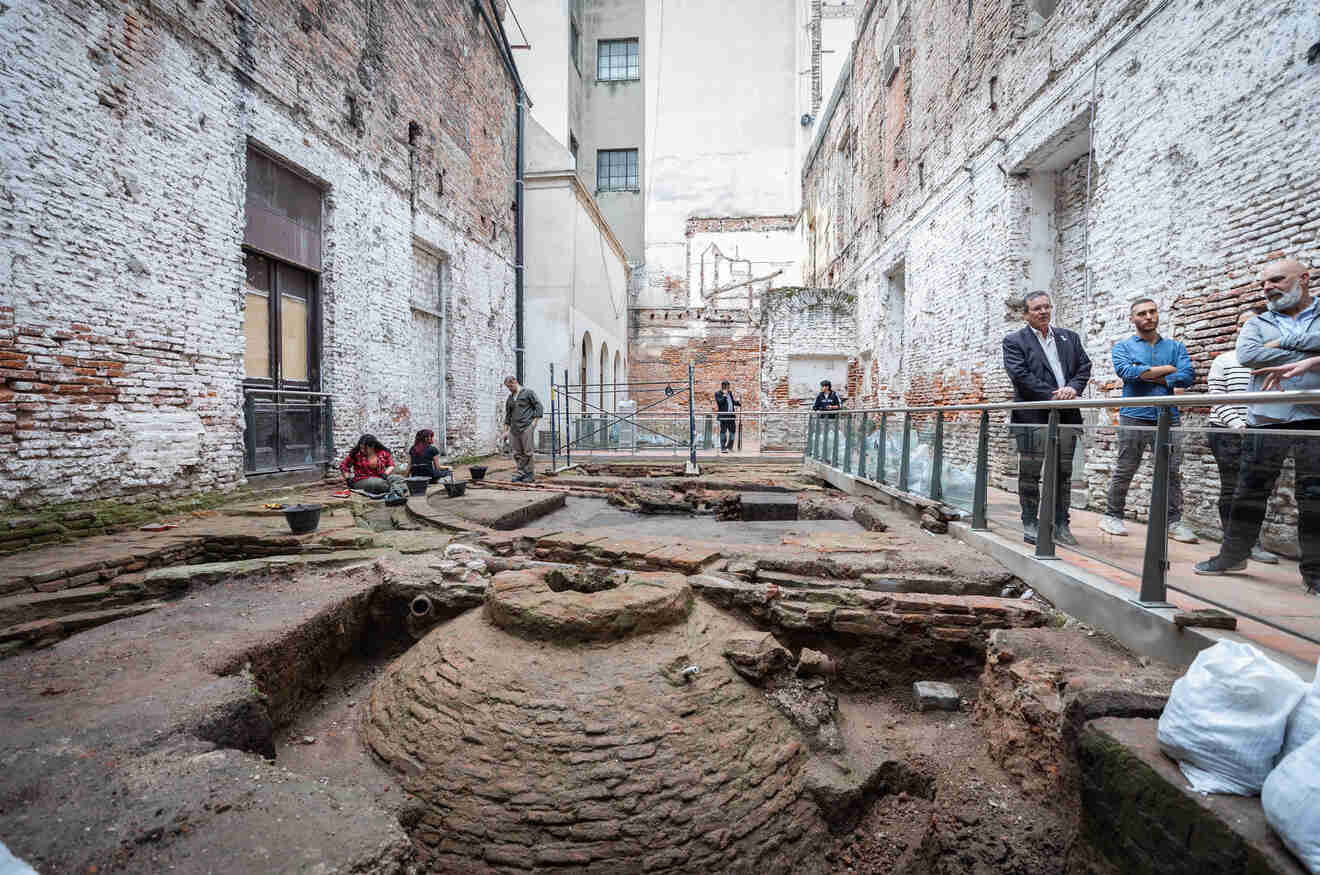 people looking at excavations at a museum