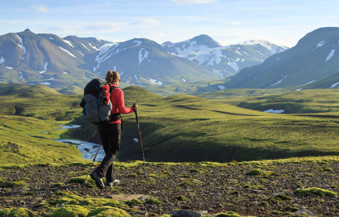 a woman with gear hiking on a mountain