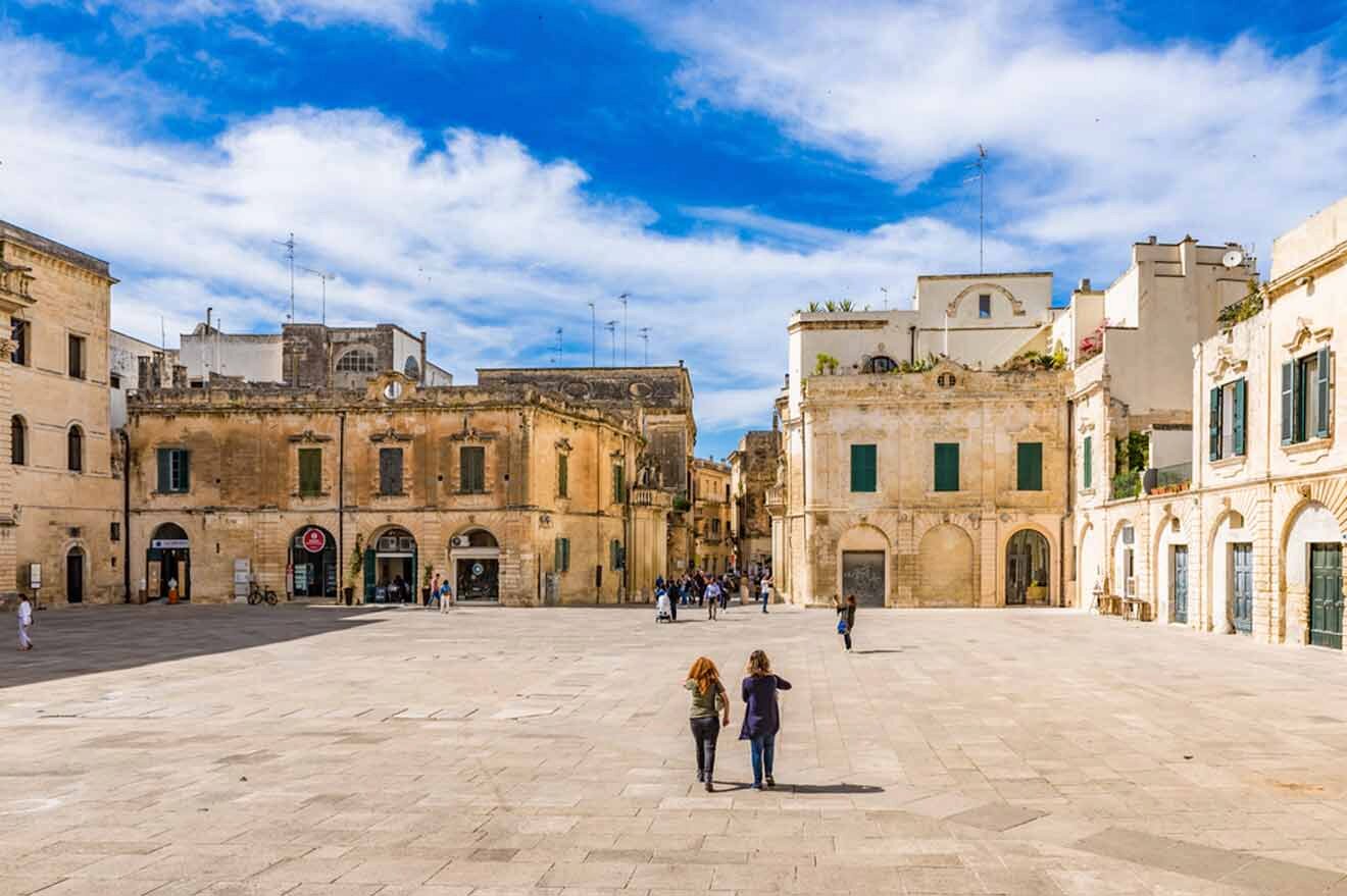 people walking in a square in a city