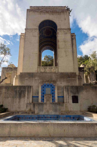 A building with a fountain in the middle of it.