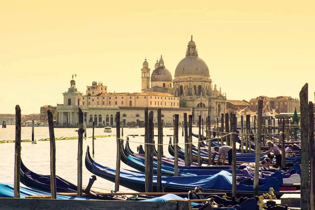 Gondolas docked on the water in venice, italy.