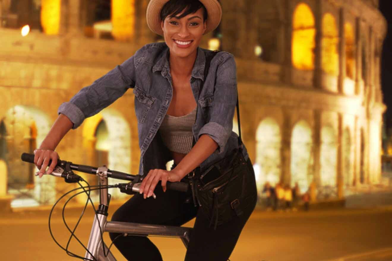 woman on a bike in front of the colosseum