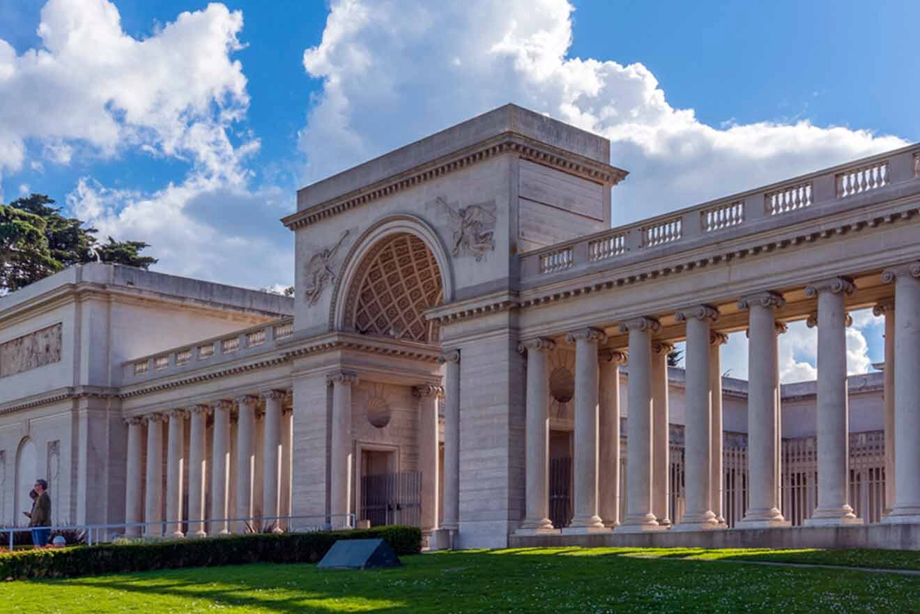 A large building with columns and a grassy area.