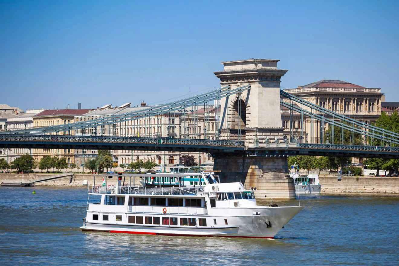 cruise boat next to a bridge in the city