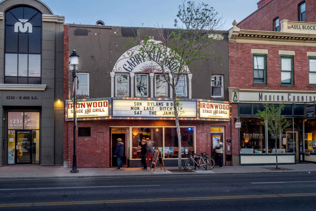 A building with a theater on the corner of a street.