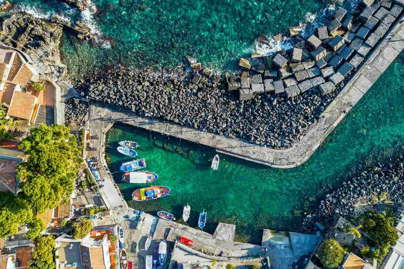 An aerial view of a town with boats docked in the harbor.