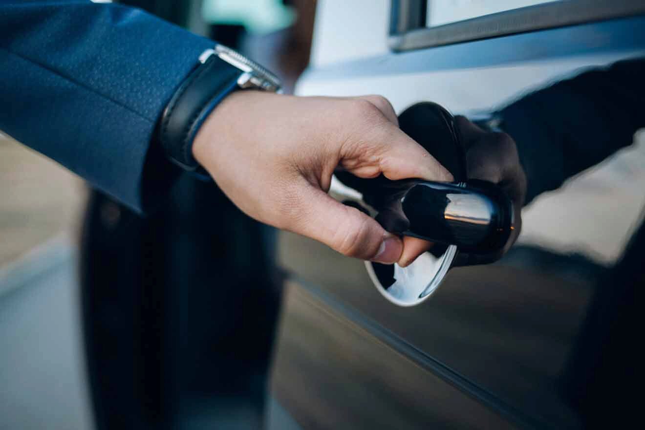 A man is opening the door of a car.