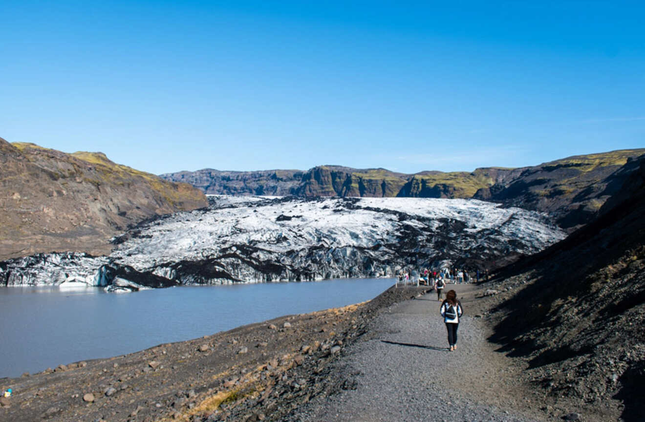 view of people hiking towards a glacier