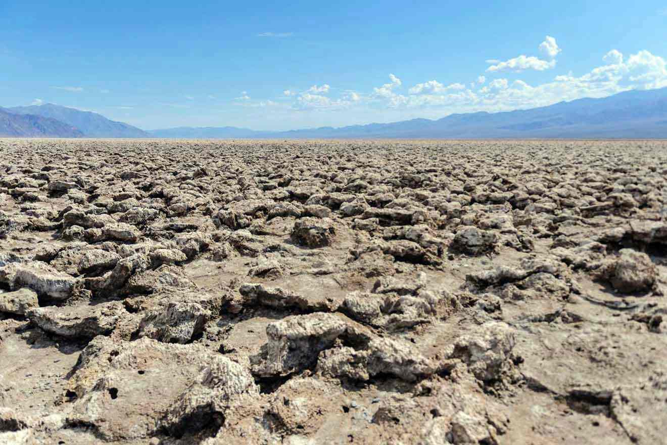 A deserted area with rocks and a blue sky.