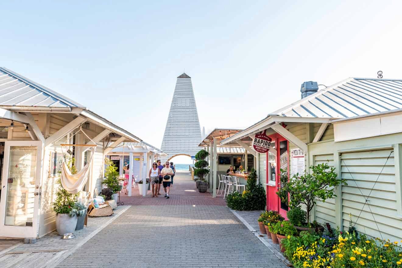 A street lined with small shops and a lighthouse.