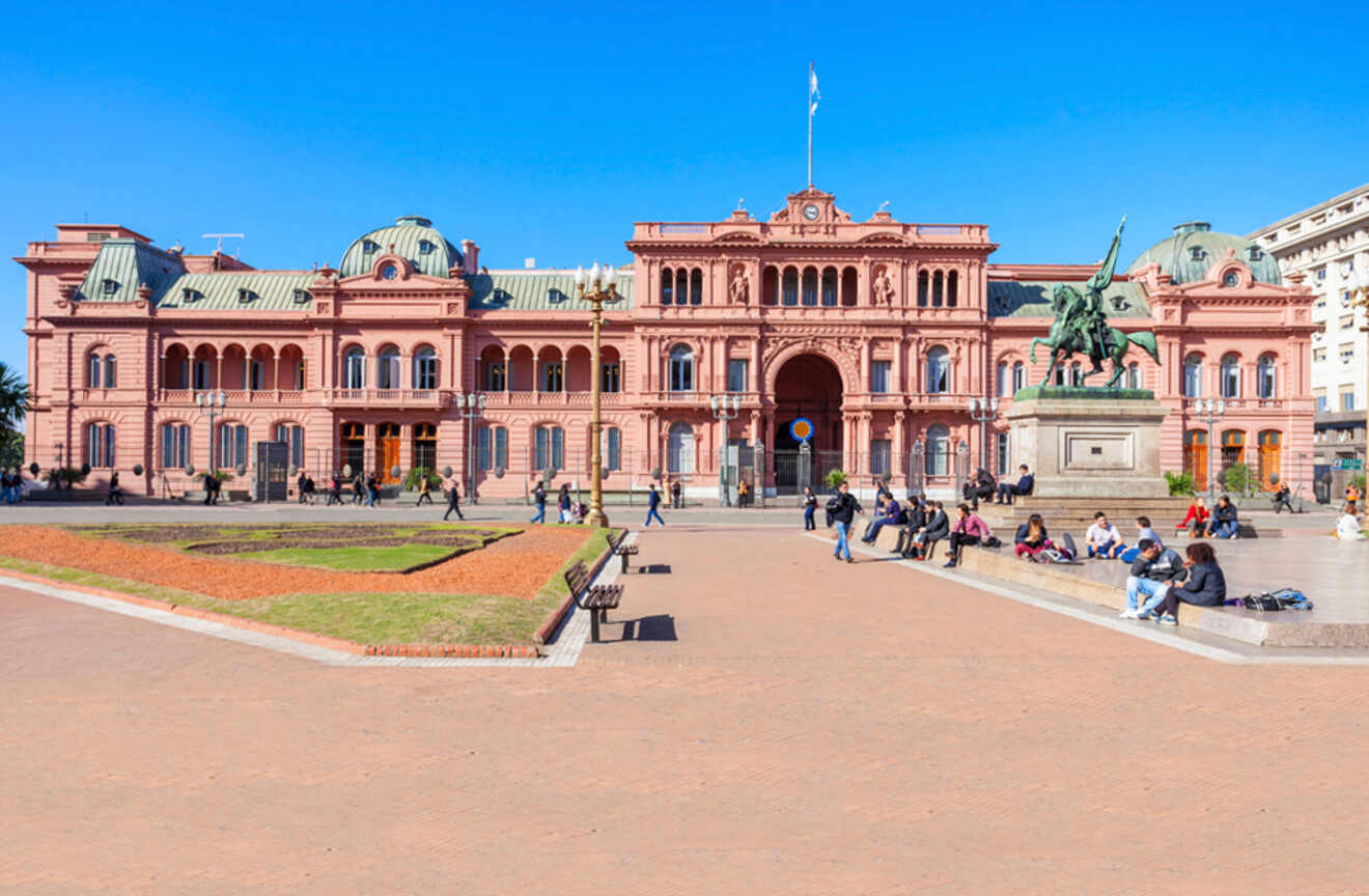 people sitting in front of a red building