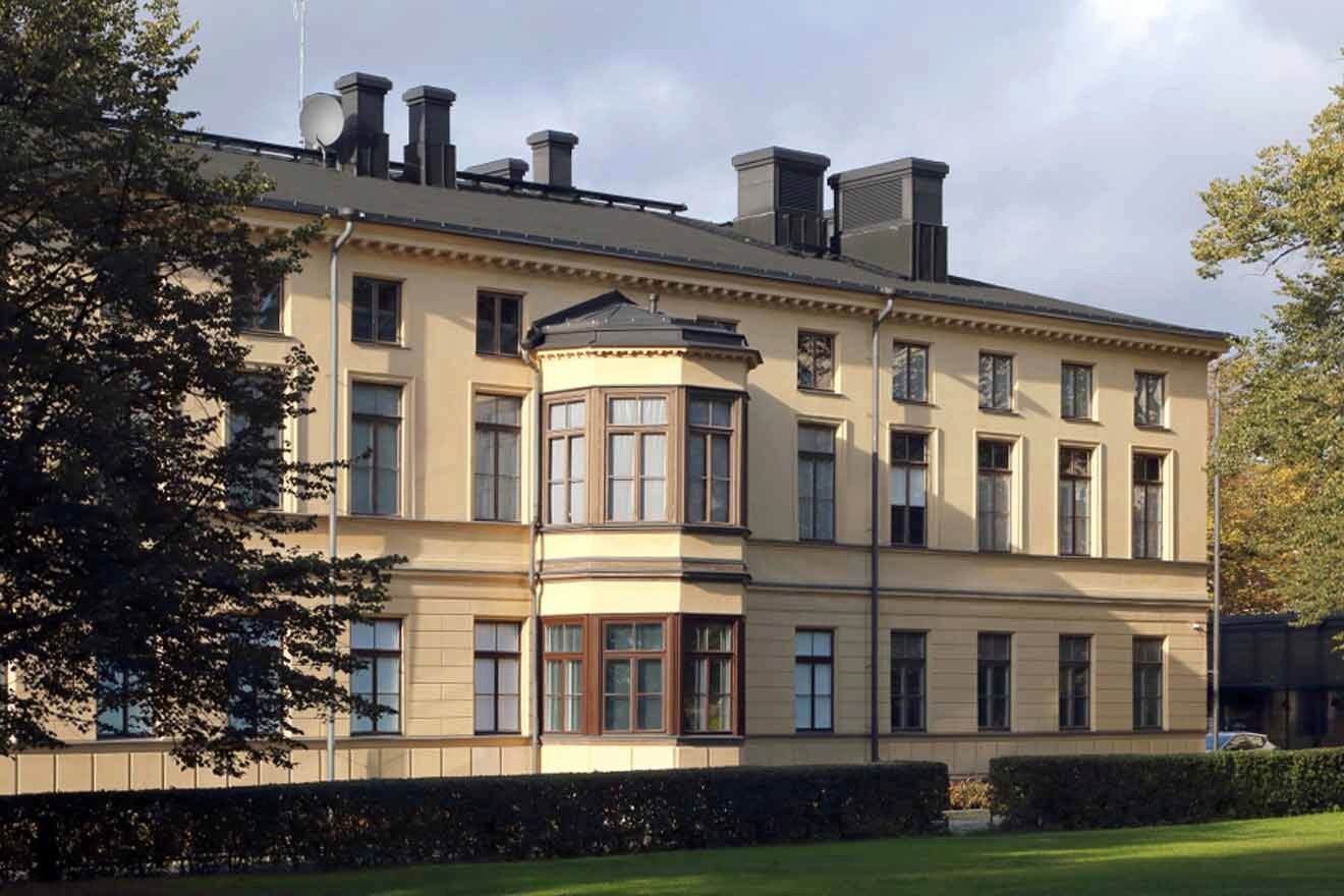 a building with trees and greenery in front of it