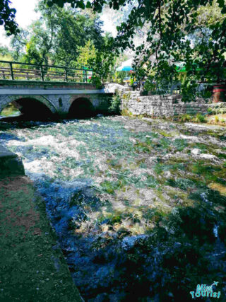 a bridge over a river flowing in the lake