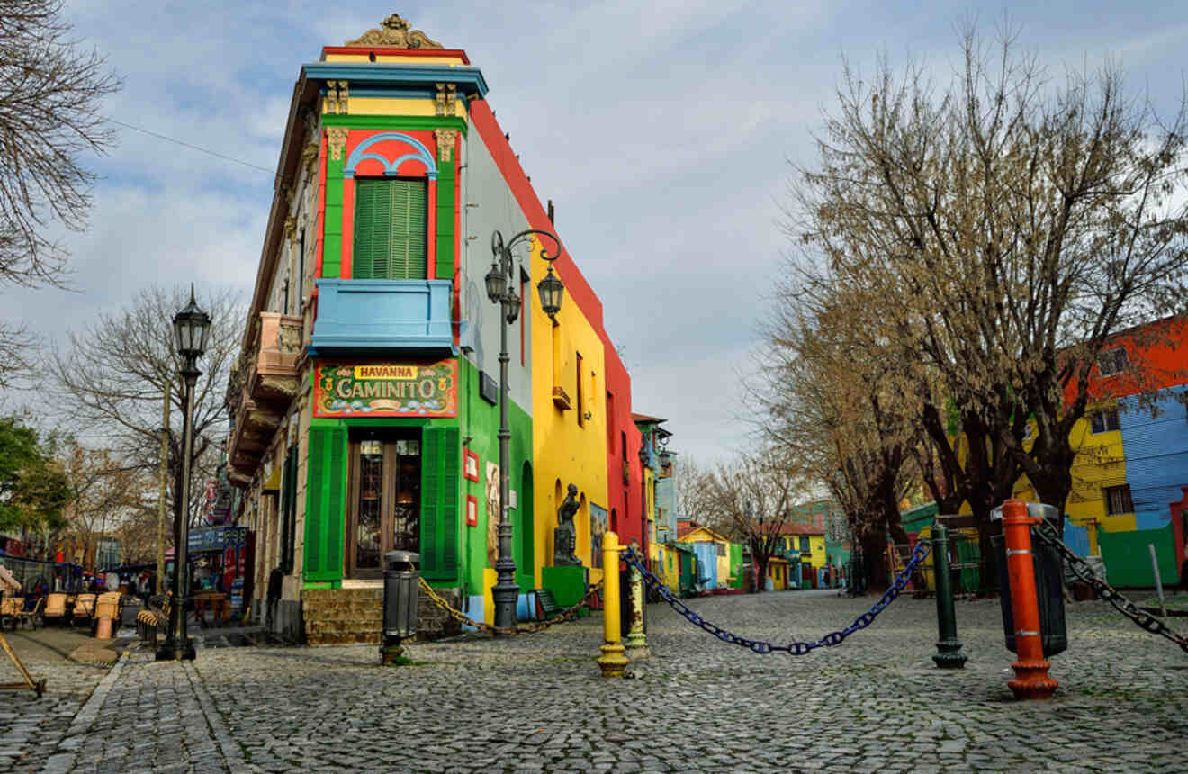 a colorful corner building on a cobbled street