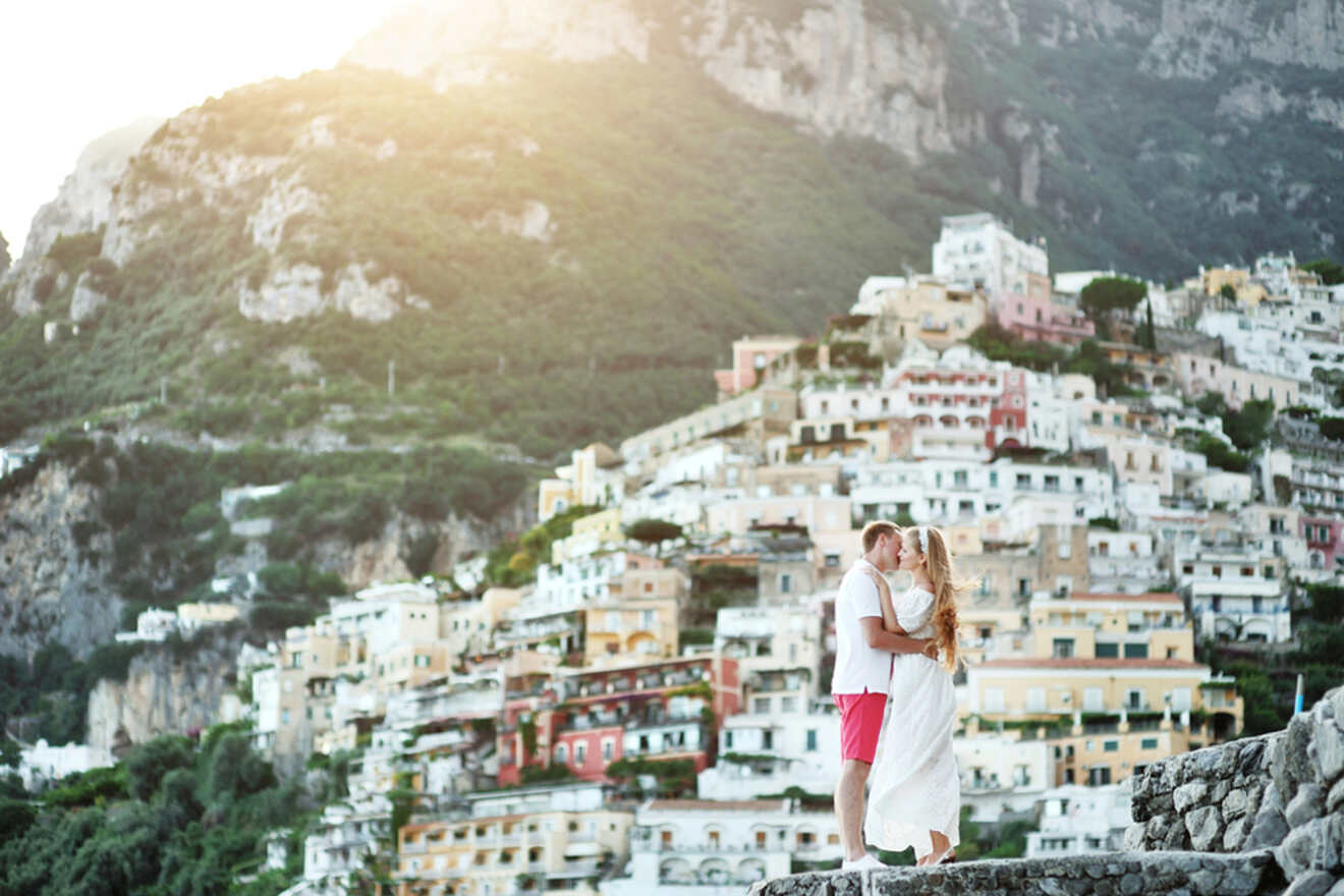 An engaged couple standing on a cliff overlooking