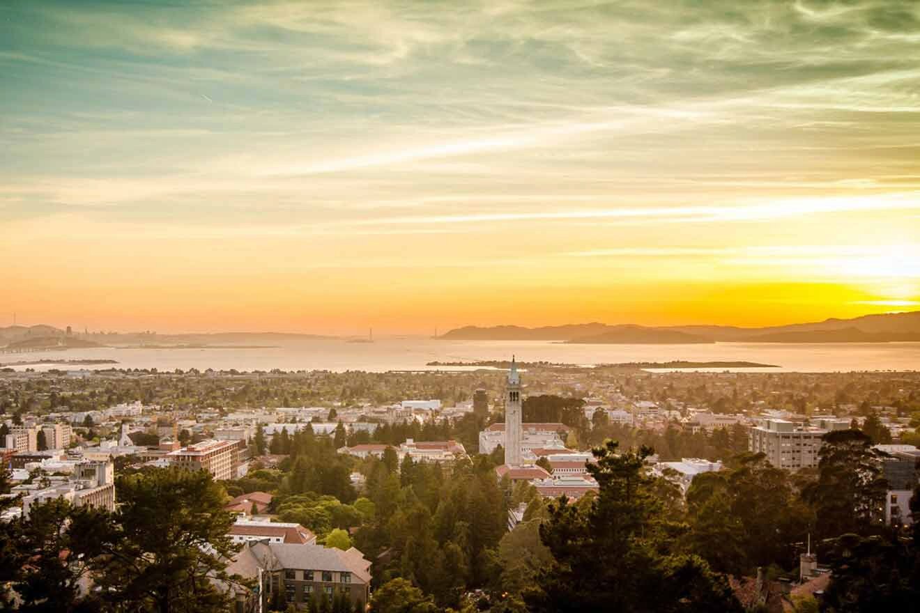 aerial view over a city with the ocean in the background at sunset