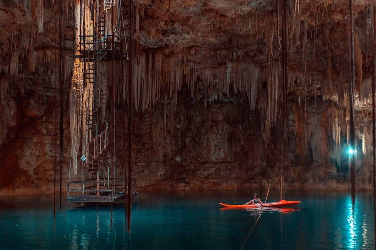 A person in a kayak in an underground cenote.