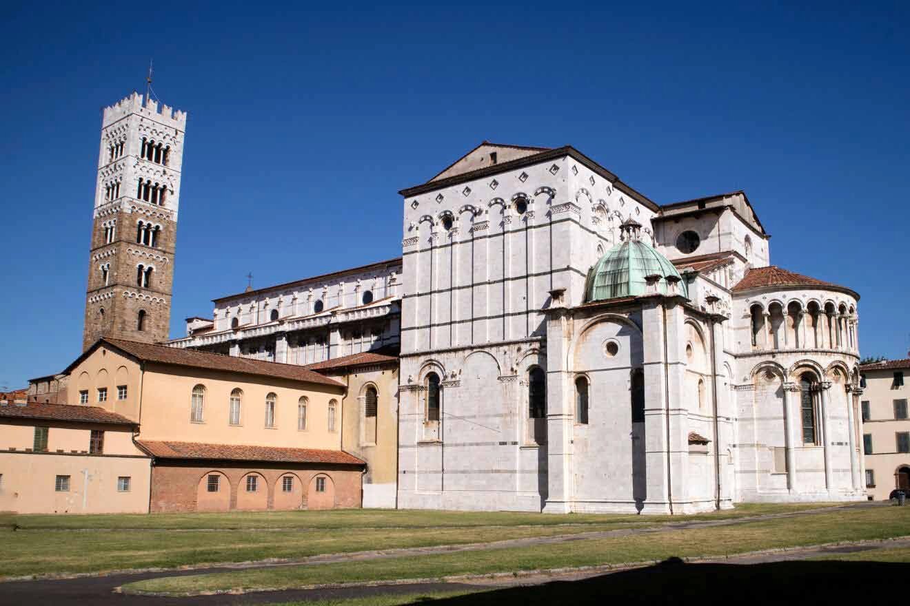 A large white church with a tower in the background.