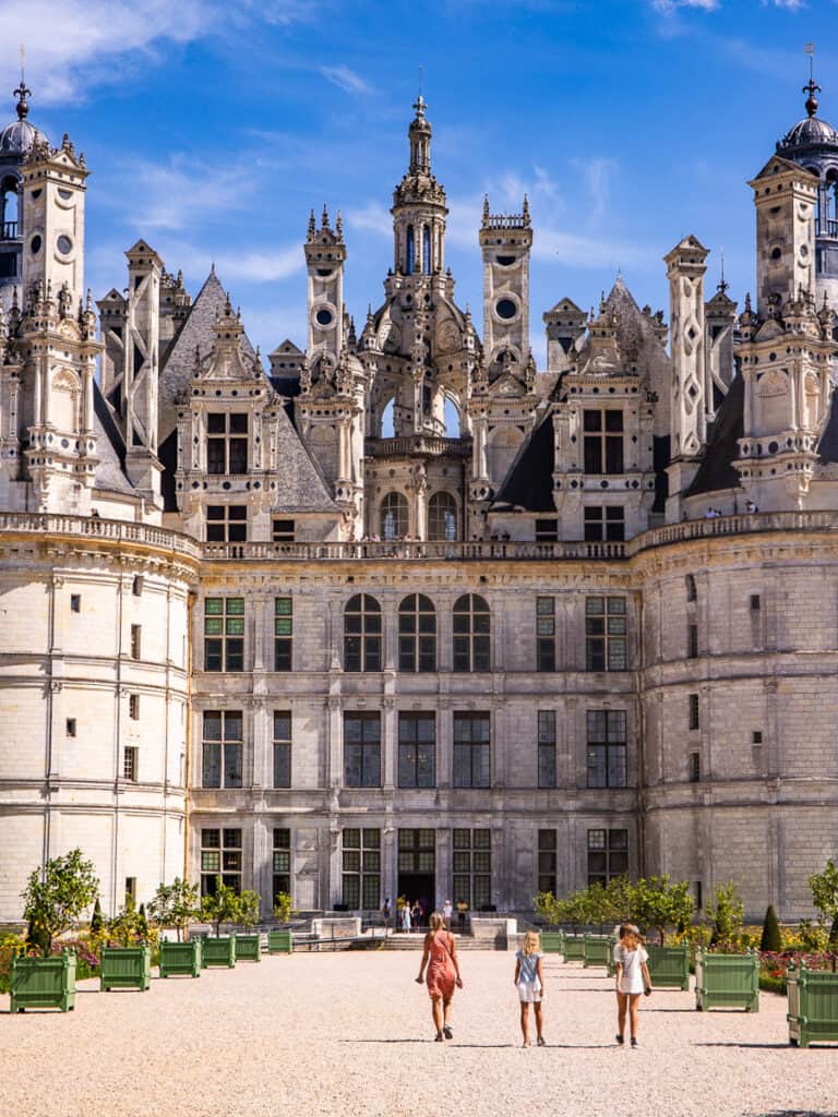 people walking in front of huge castle