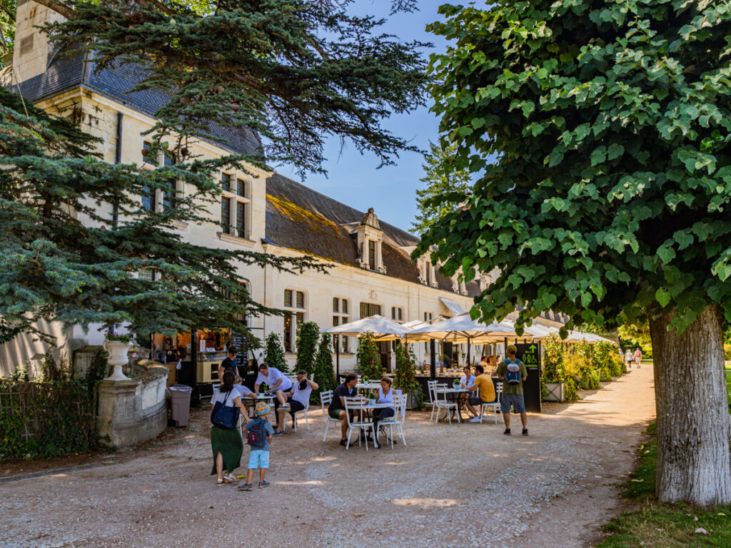 people sitting at tables in the village