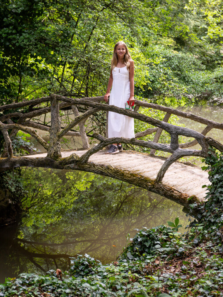 savannah standing on wooden bridge across crek