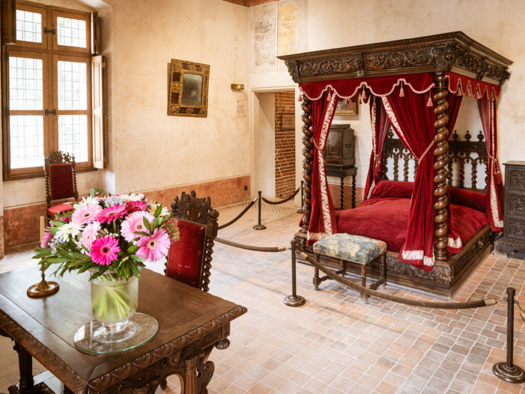 red bedroom and desk inside Leonardo da Vinci room