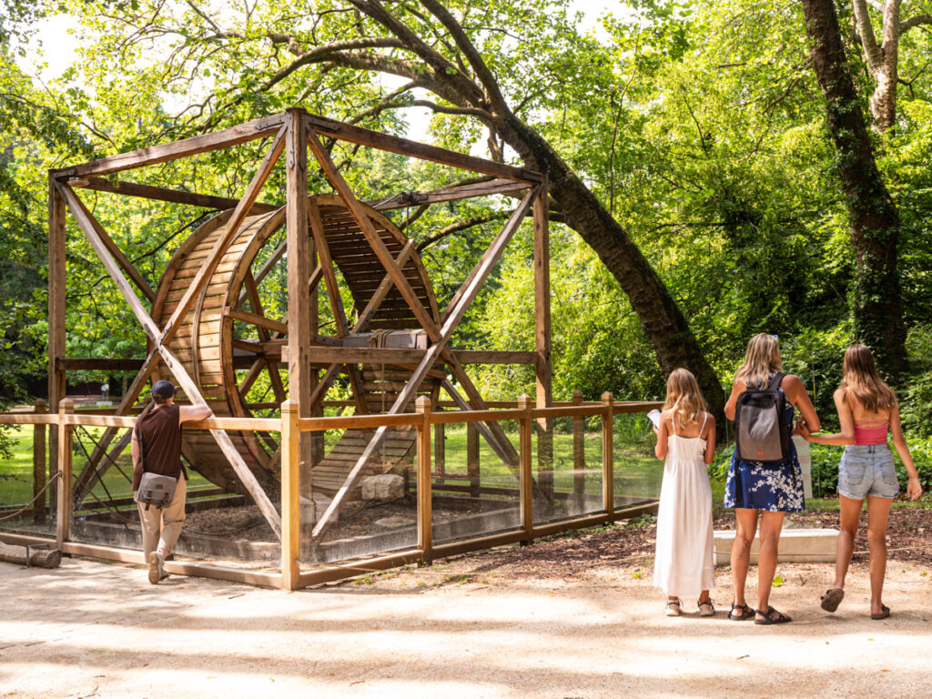 girls looking at wooden sculpture of da vinci invention