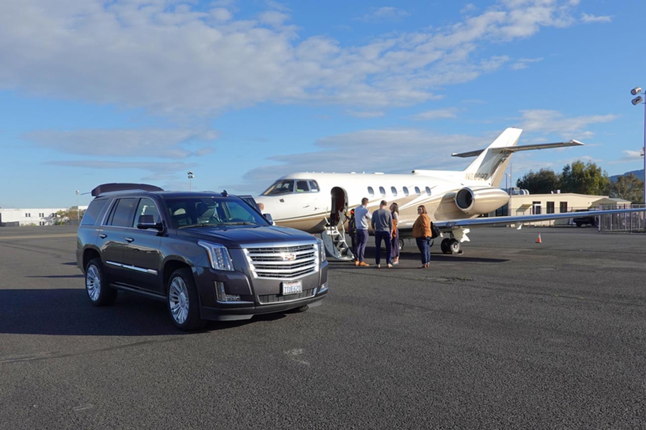 a car parked next to an airplane